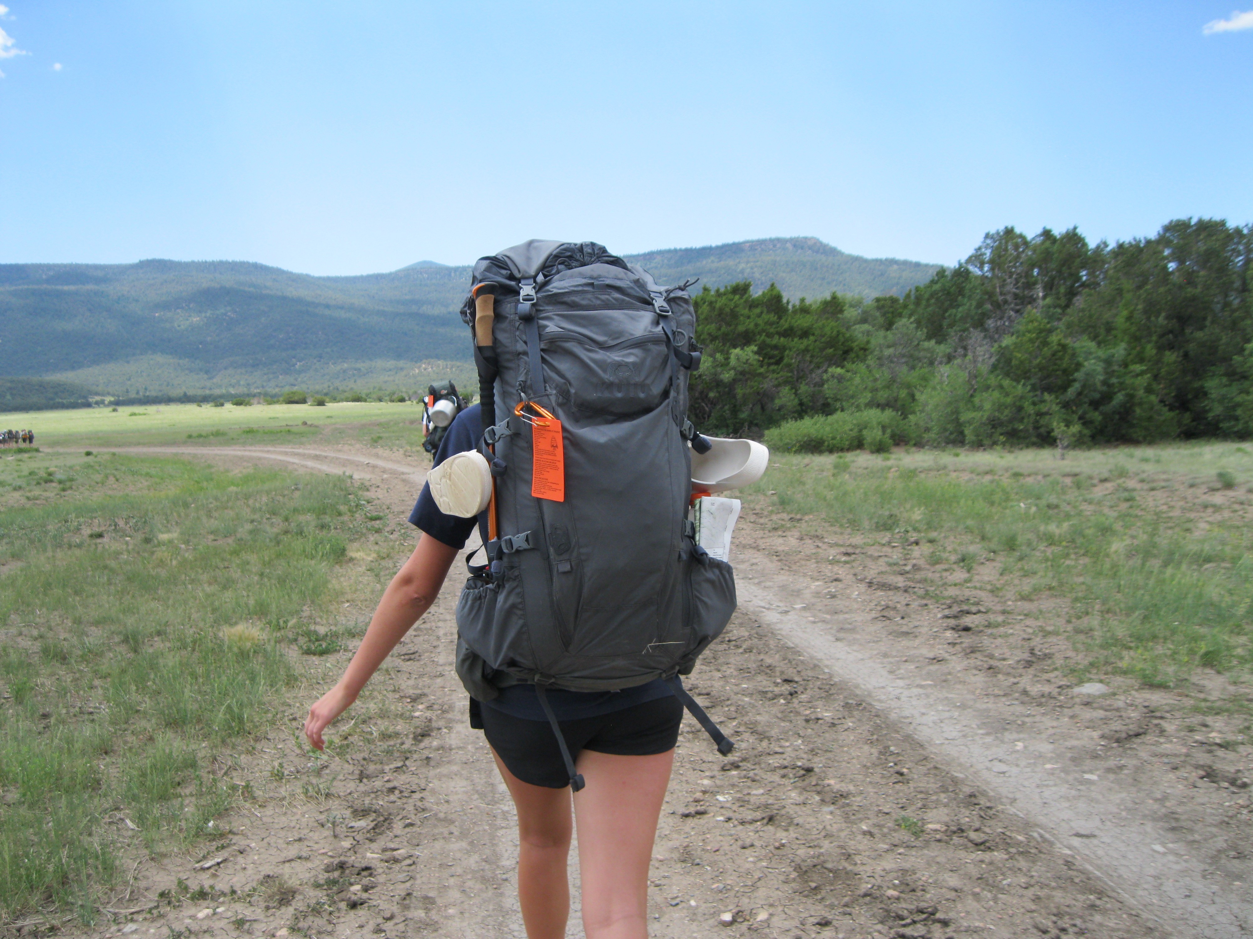 Cora backpacking on a trail