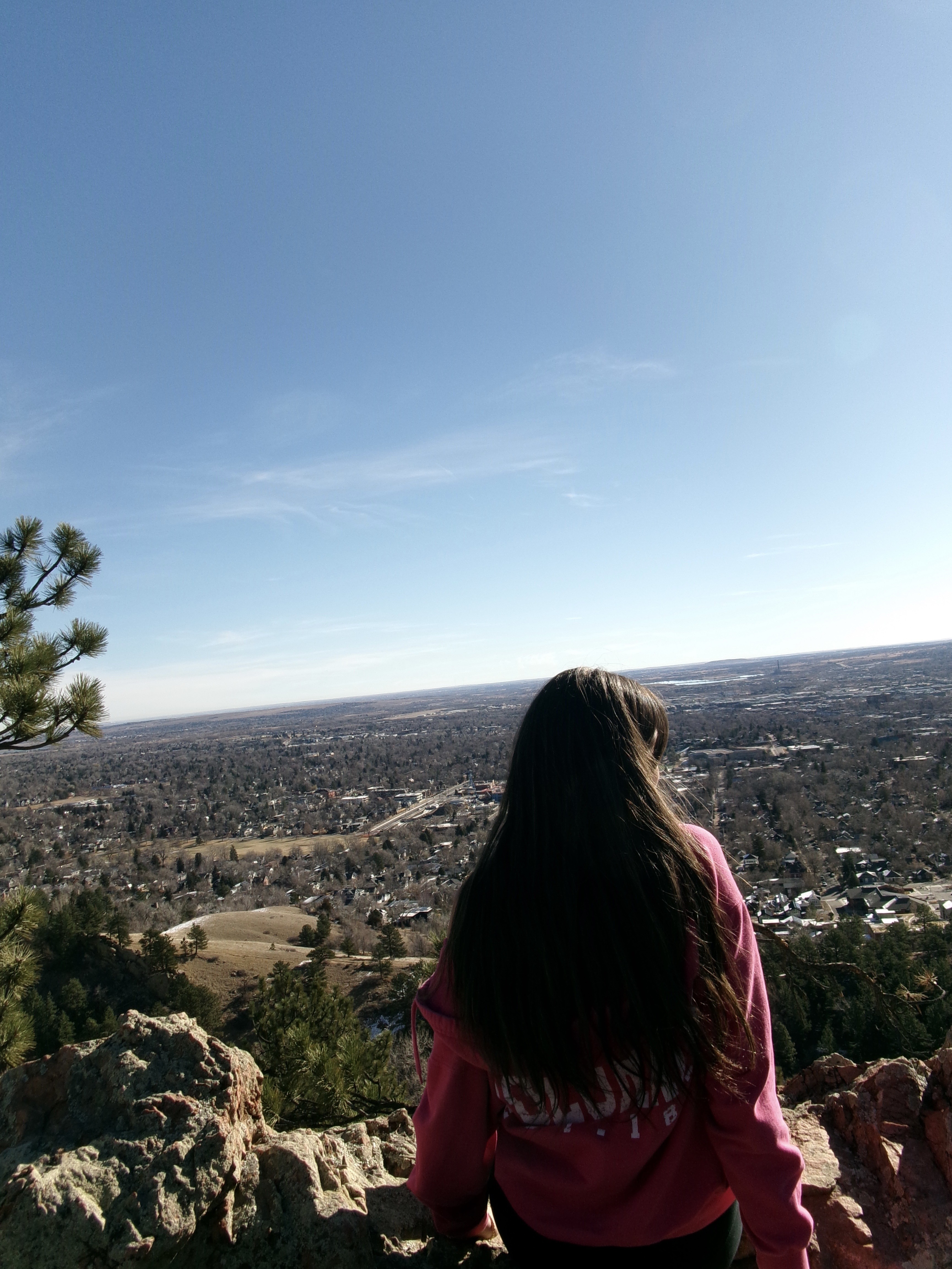 Cora sitting on a rock overlook